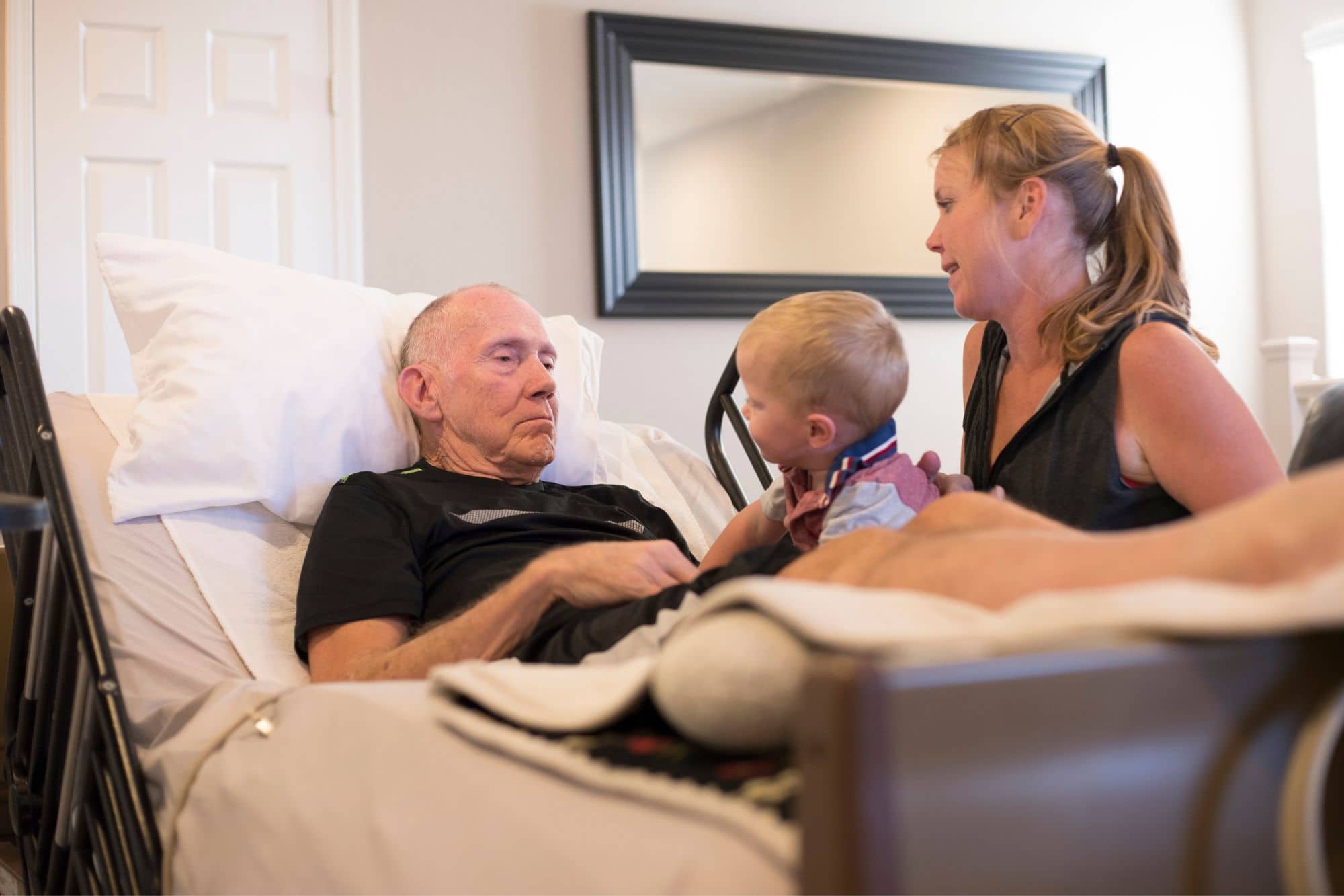 elderly home hospice patient with her daughter and grandson