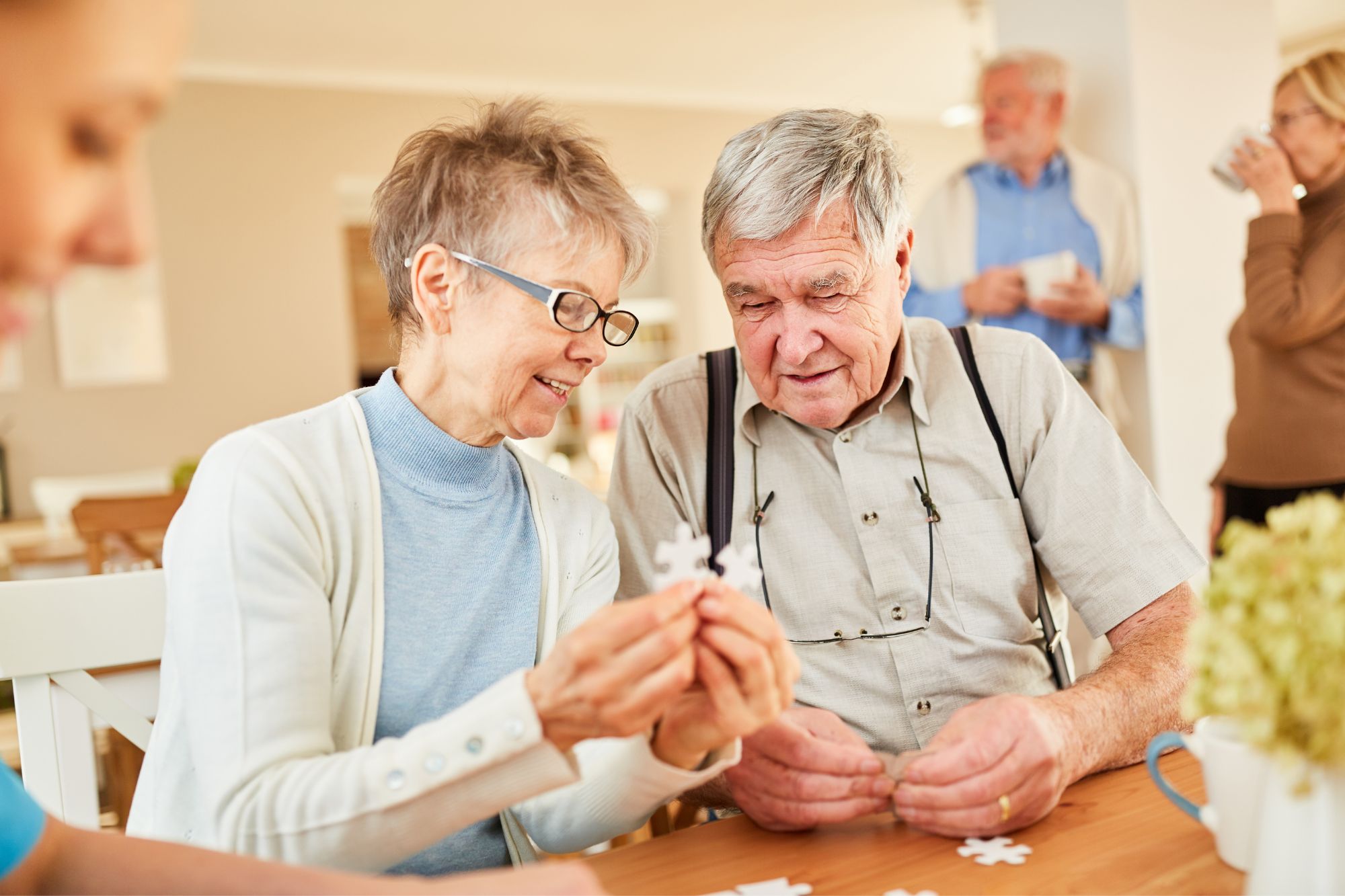 senior couple with dementia playing puzzle in an assisted living community