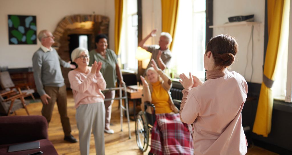 diverse group of senior people dancing while enjoying in assisted living
